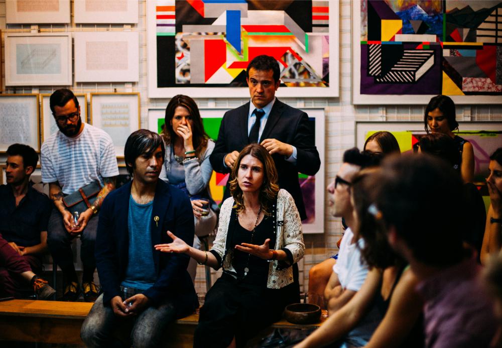 Group engaged in art gallery discussion.